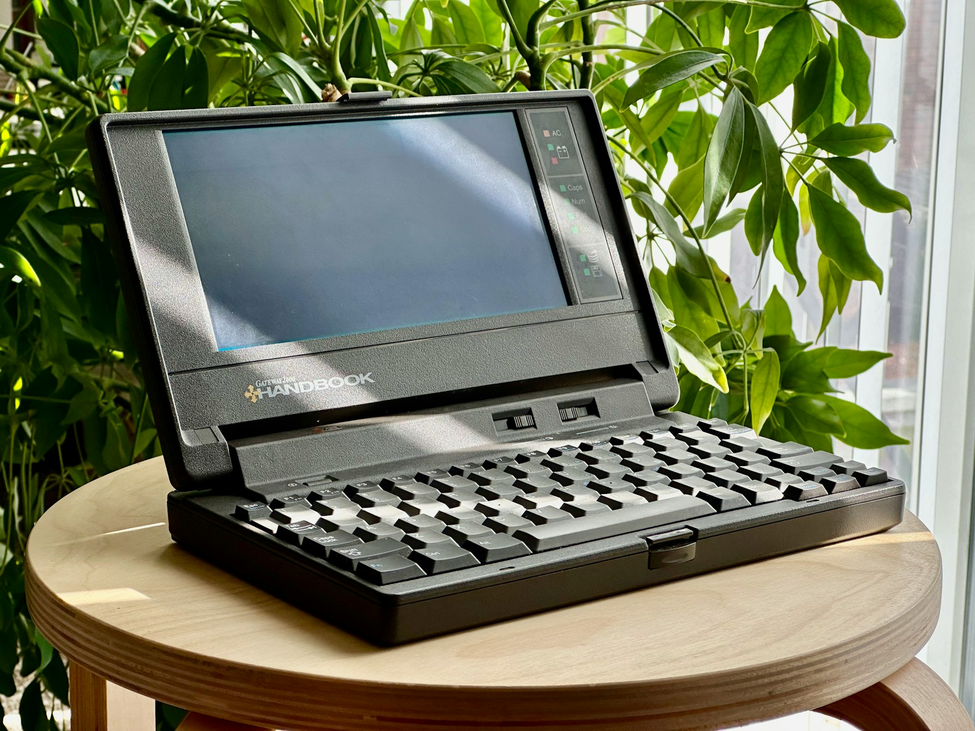 a laptop computer sitting on top of a wooden table